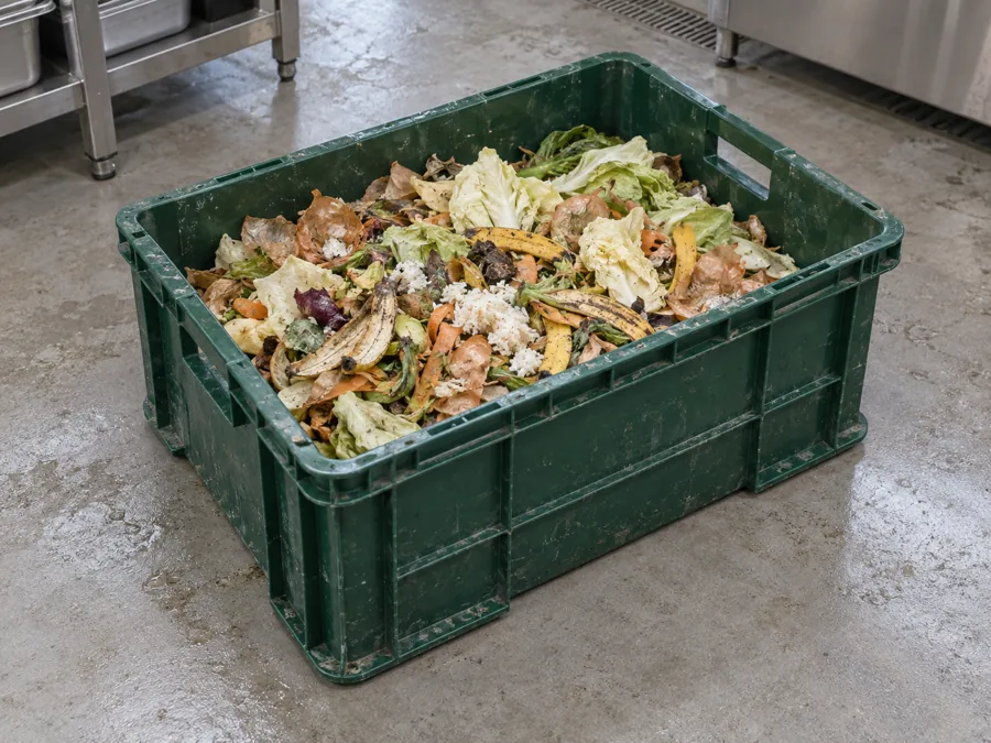 Segregated kitchen food scraps in an industrial collection crate